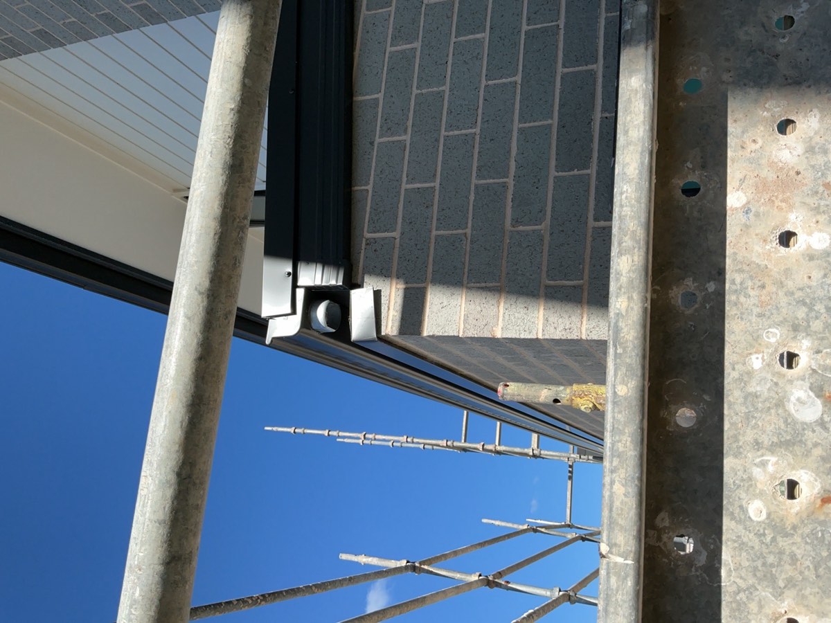 Downpipe not installed to ground floor, recorded during a fixing stage inspection in Austral